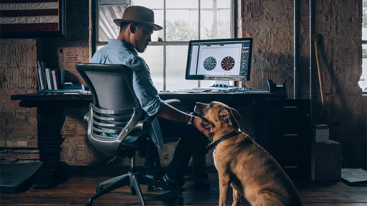 Man at computer with dog